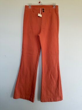 LA MIEL Flared Pants in Rust Orange